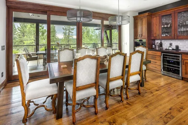 a dining room with furniture a chandelier and wooden floor