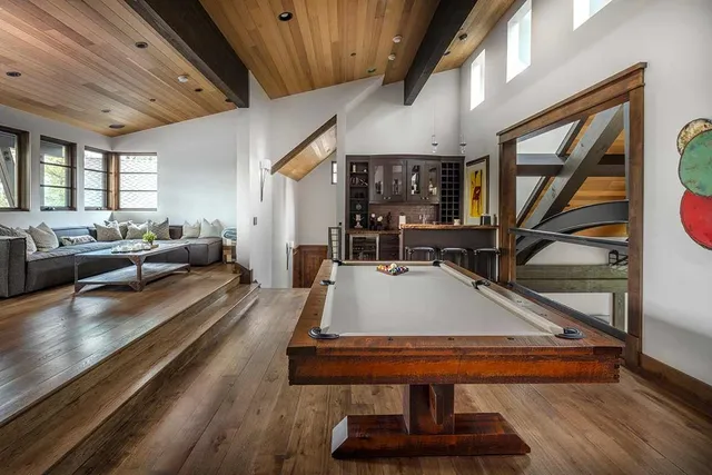a living room with furniture a rug and a chandelier