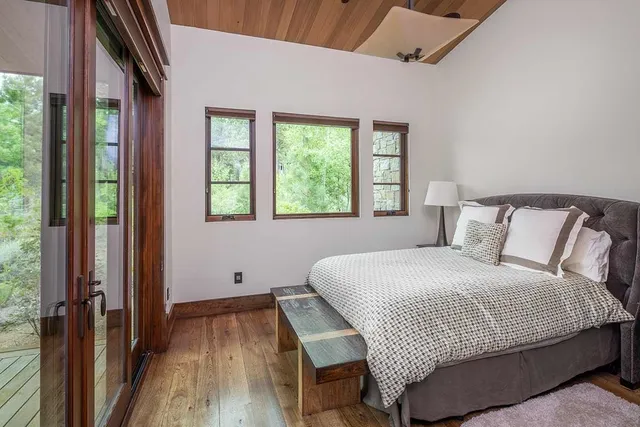 a bedroom with a bed and a large window