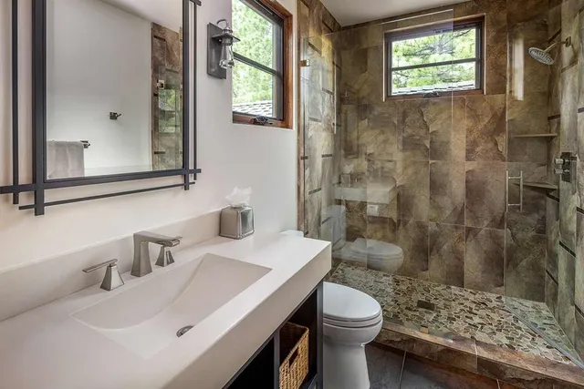 a bathroom with a sink toilet and shower