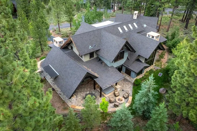 an aerial view of a house with garden space and street view