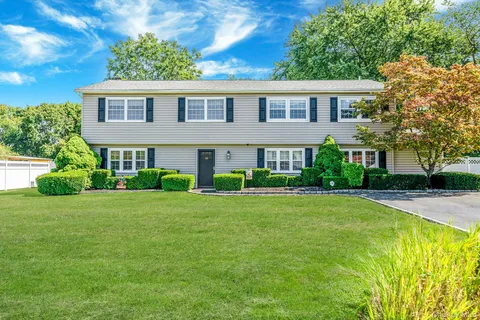 a view of a big yard with a house in the background