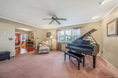 a living room with furniture and a piano