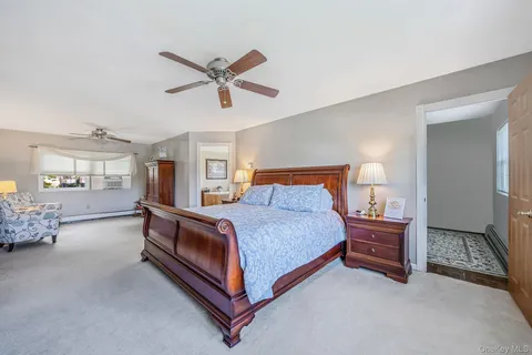 a bed room with a bed and a chair