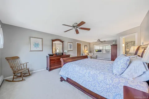 a bedroom with a large bed a window and dresser