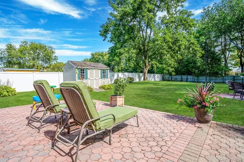a view of a chairs and table in backyard