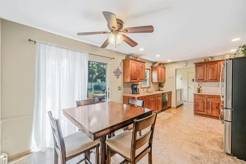 a kitchen with a table chairs refrigerator and cabinets