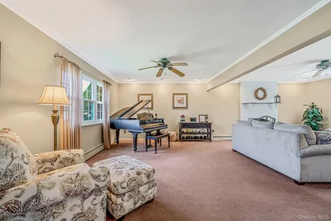 a bedroom with furniture and a large window