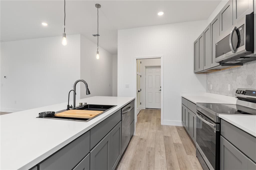 13514 Keystone Boulevard Port Charlotte, FL 33981 - Photo 13 of 42 a kitchen that has a sink and a stove