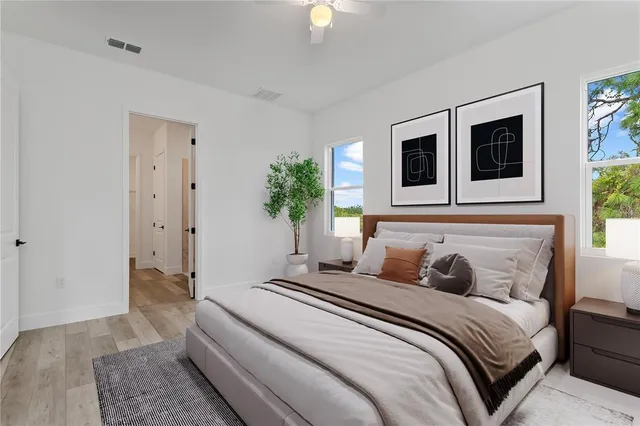 a bedroom with a bed and a chandelier