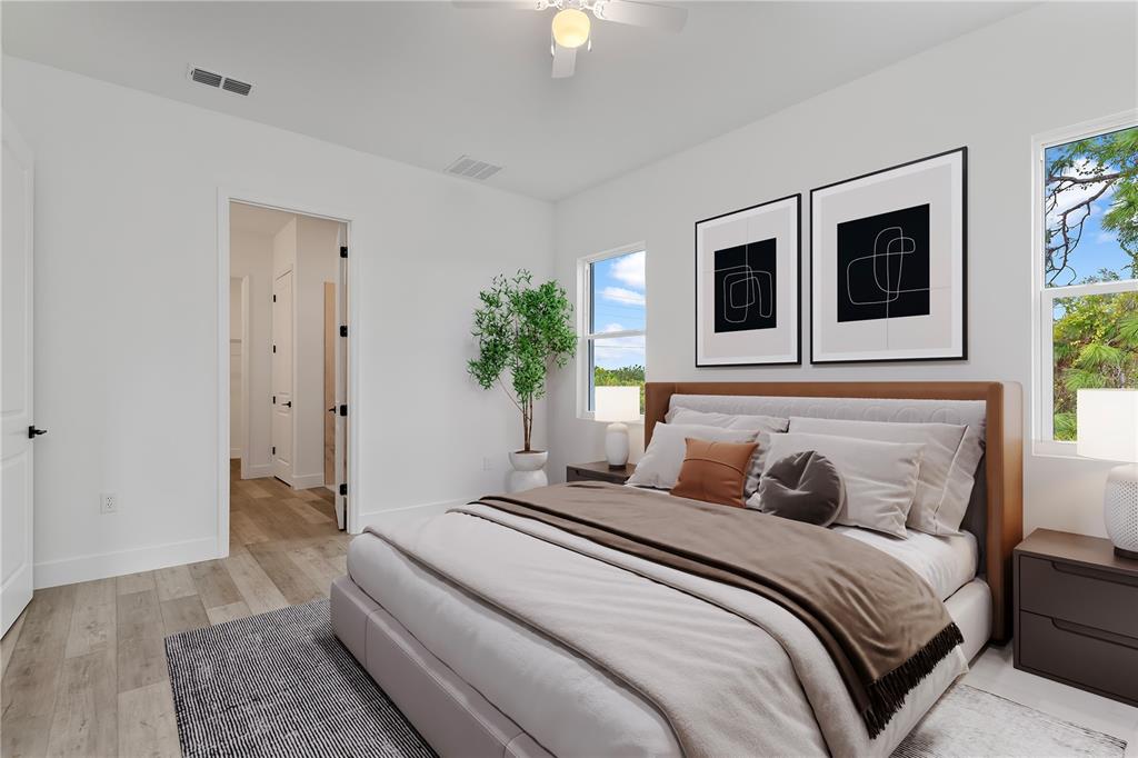 13514 Keystone Boulevard Port Charlotte, FL 33981 - Photo 16 of 42 a bedroom with a bed and a chandelier