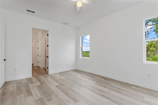 wooden floor in an empty room with a window