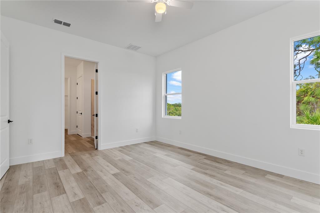 13514 Keystone Boulevard Port Charlotte, FL 33981 - Photo 17 of 42 wooden floor in an empty room with a window