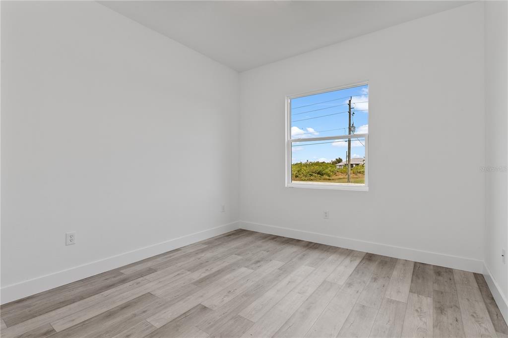 13514 Keystone Boulevard Port Charlotte, FL 33981 - Photo 28 of 42 a view of an empty room with wooden floor and a window