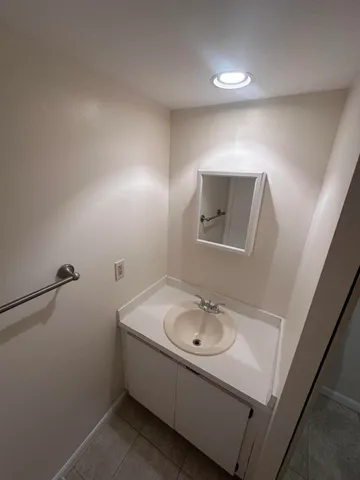 a bathroom with a sink and mirror