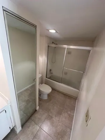a bathroom with a shower and a toilet