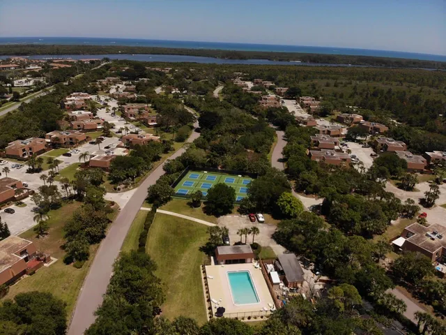 an aerial view of residential houses with outdoor space