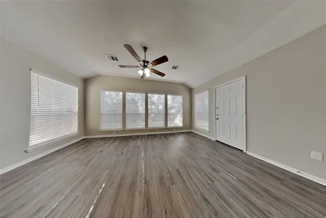 wooden floor in an empty room with a window