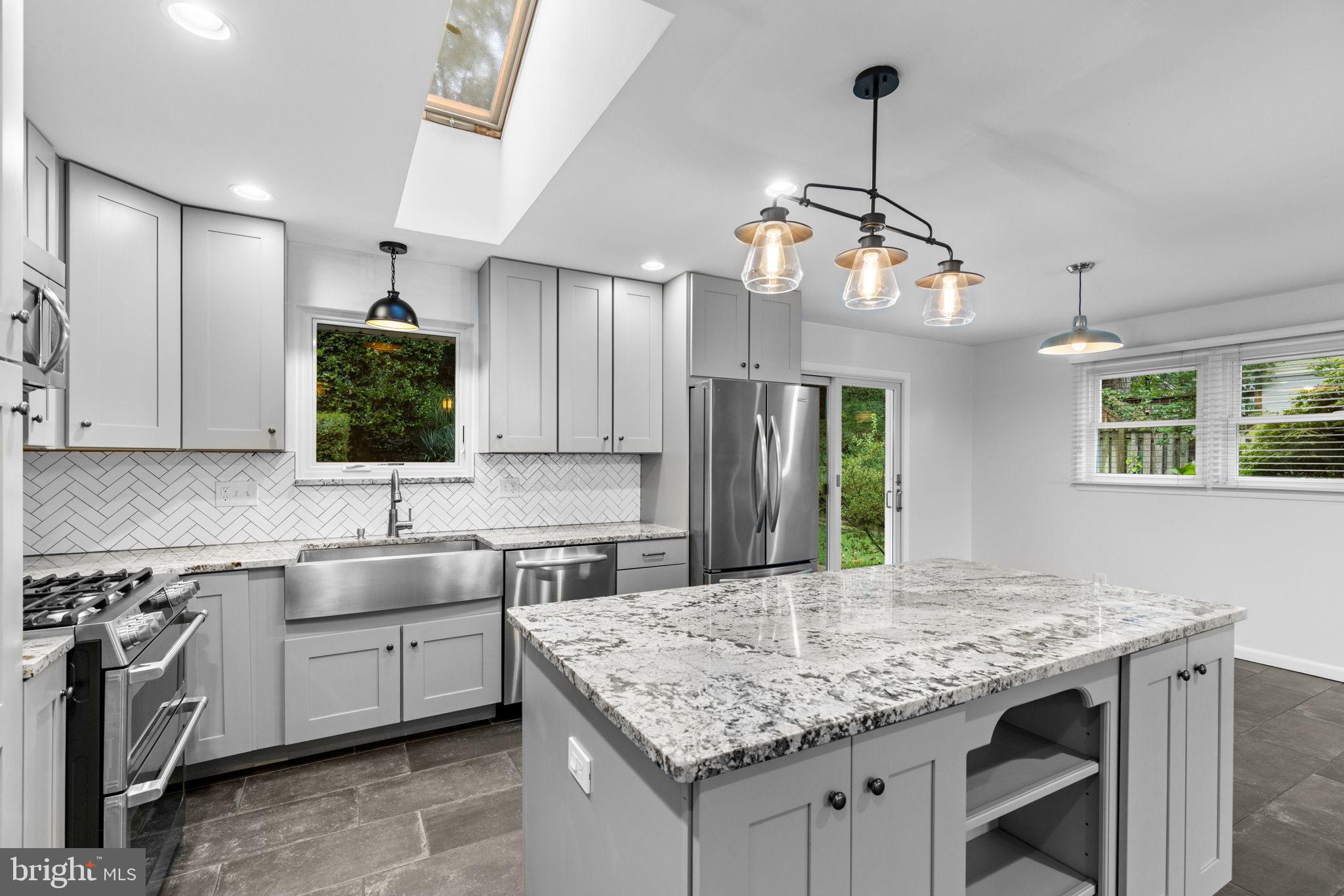 5920 Atteentee Road Springfield, VA 22150 - Photo 11 of 33 a kitchen with kitchen island granite countertop a sink center island and stainless steel appliances