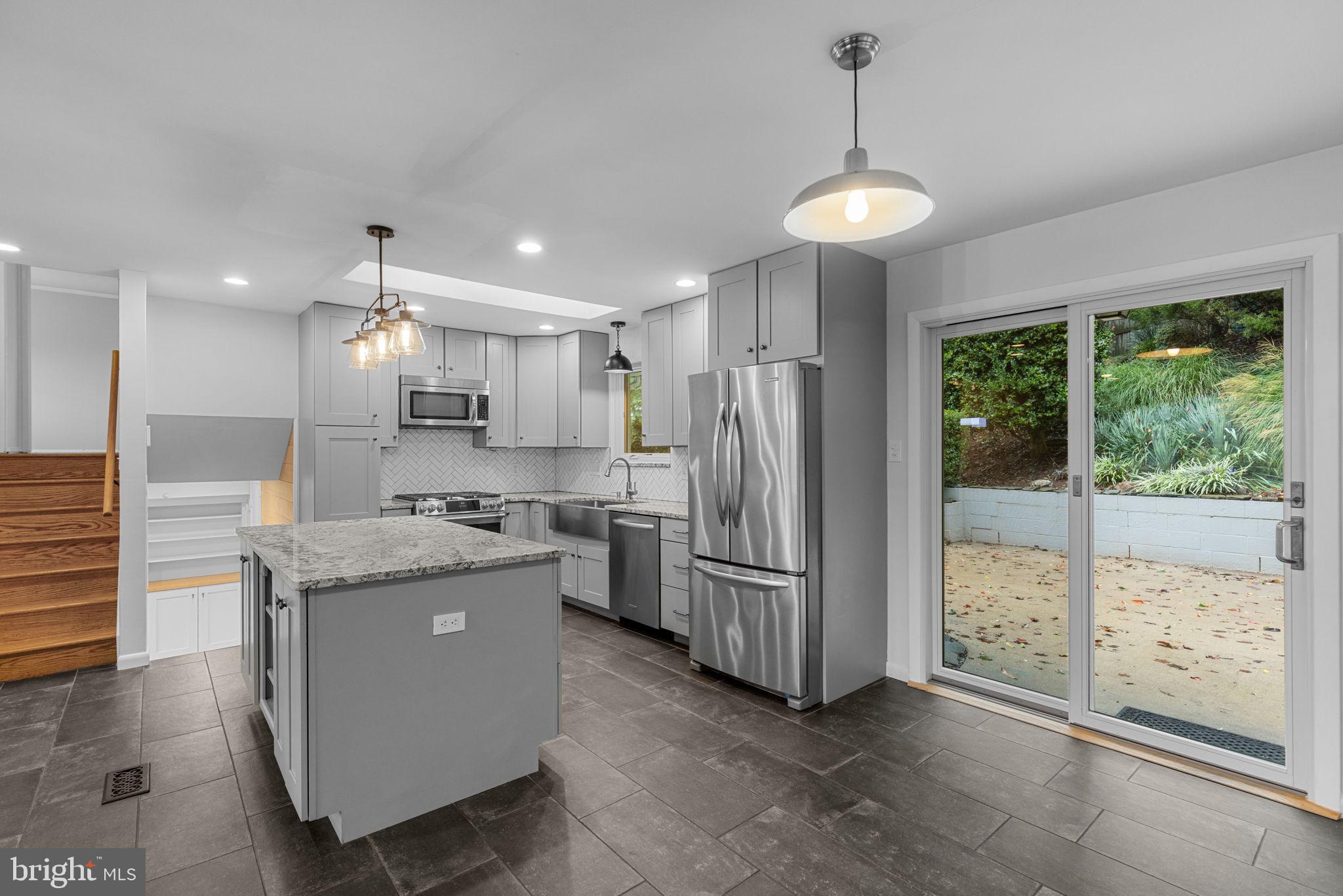 5920 Atteentee Road Springfield, VA 22150 - Photo 13 of 33 a kitchen with kitchen island granite countertop a refrigerator and a view of living room