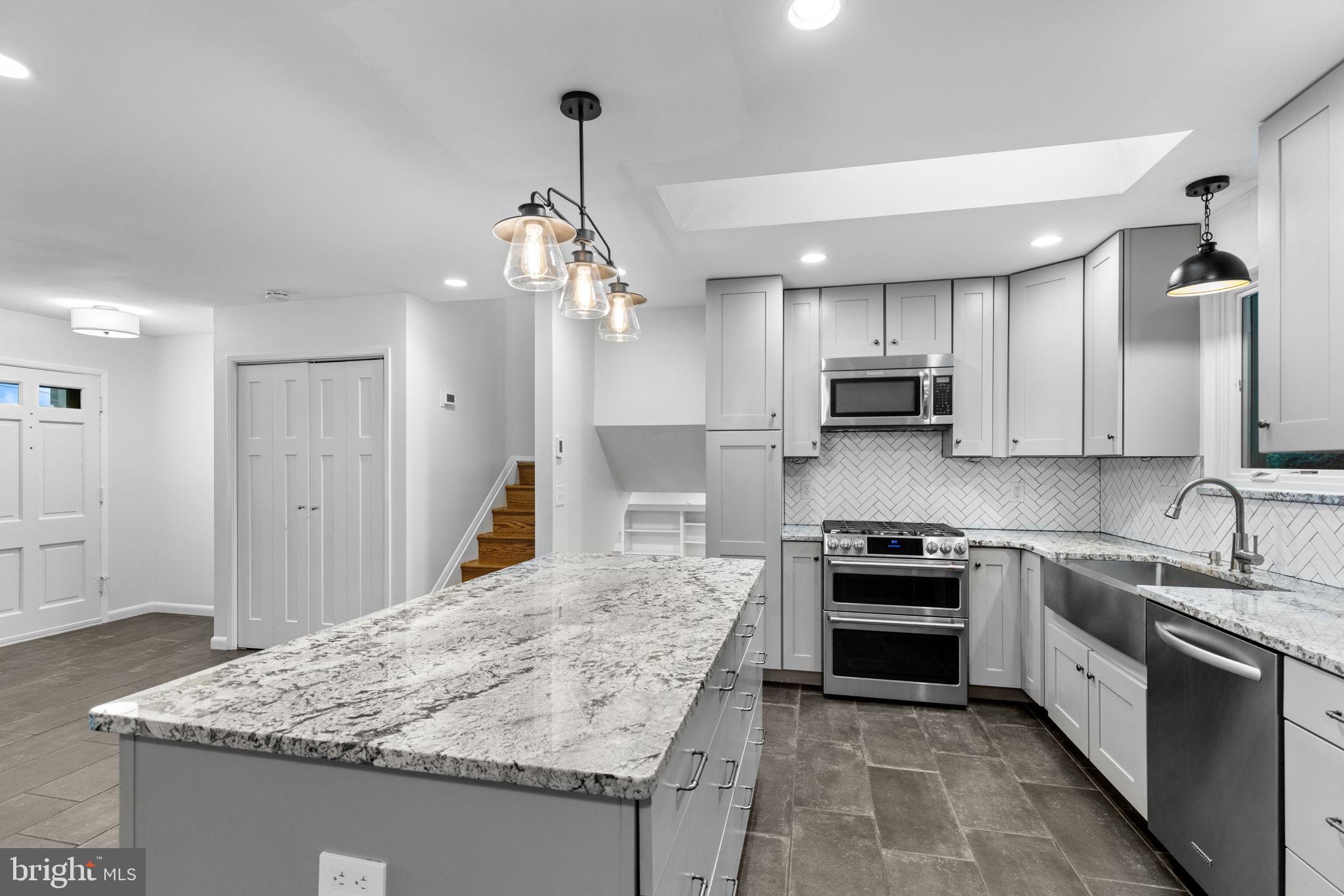 5920 Atteentee Road Springfield, VA 22150 - Photo 14 of 33 a kitchen with stainless steel appliances granite countertop a sink stove and refrigerator