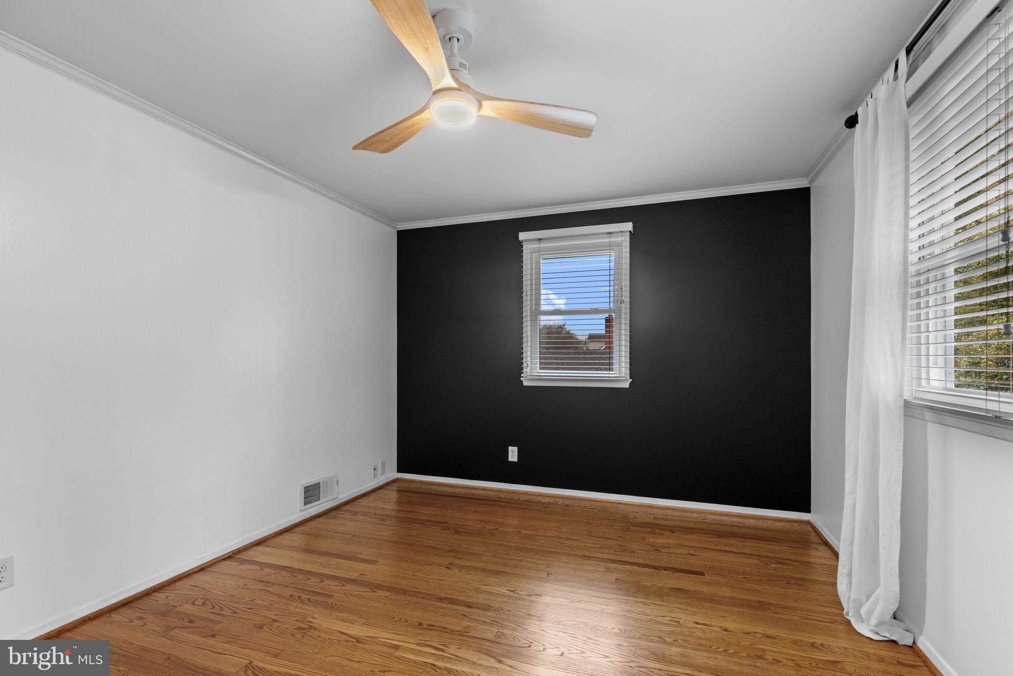 5920 Atteentee Road Springfield, VA 22150 - Photo 15 of 33 a view of an empty room with wooden floor and a window