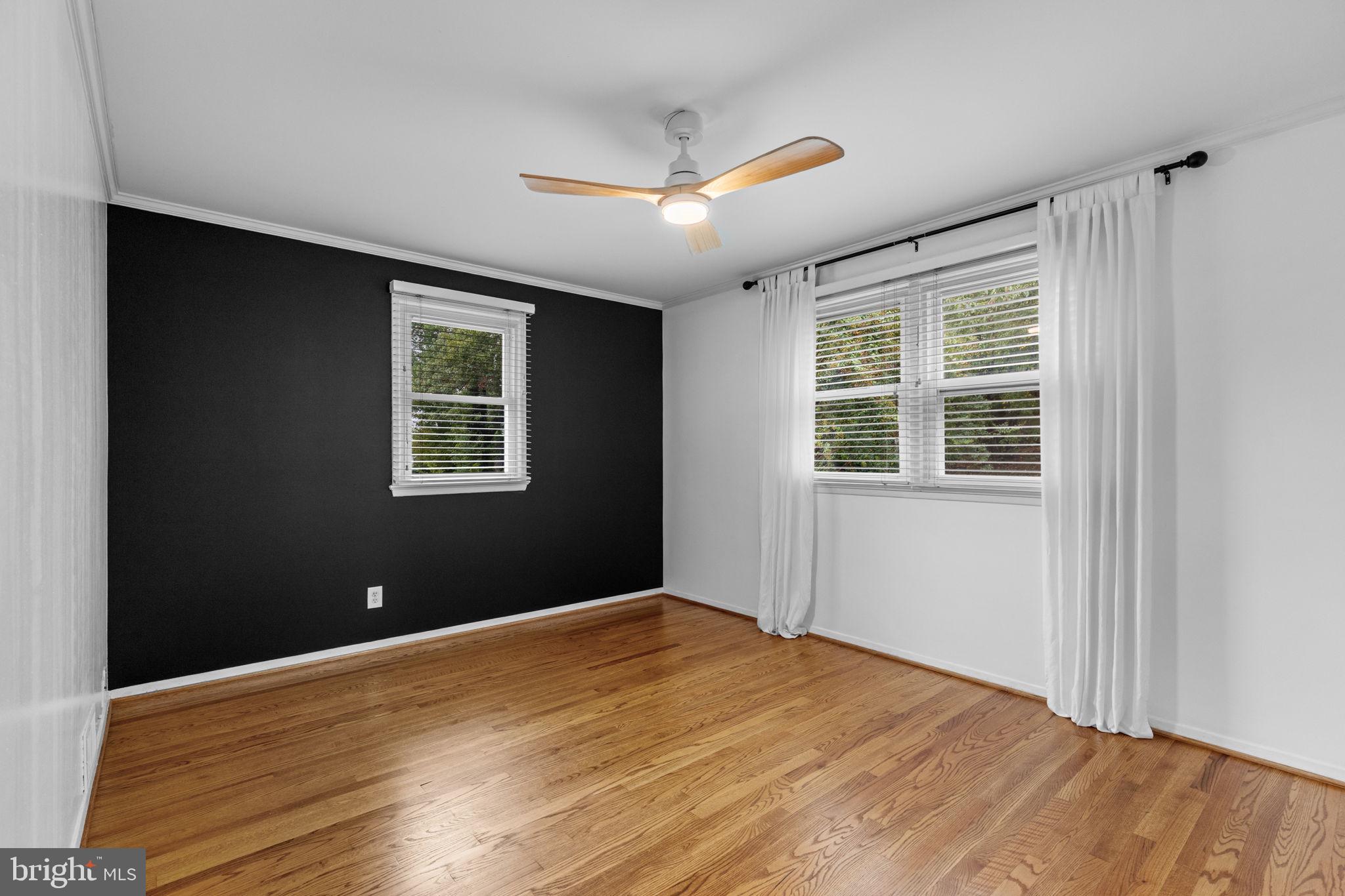 5920 Atteentee Road Springfield, VA 22150 - Photo 16 of 33 a view of an empty room with wooden floor and a window