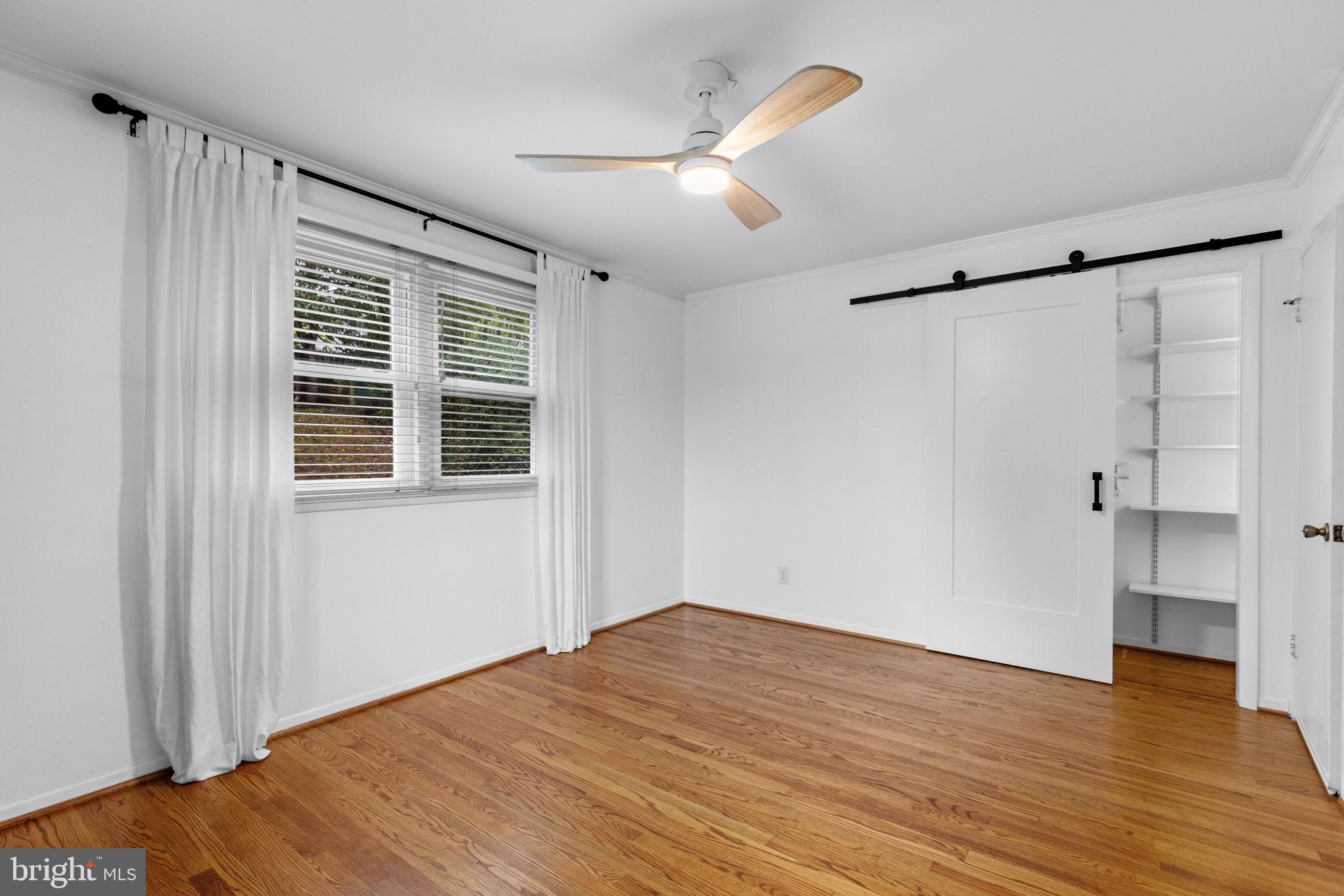 5920 Atteentee Road Springfield, VA 22150 - Photo 17 of 33 a view of empty room with wooden floor and fan