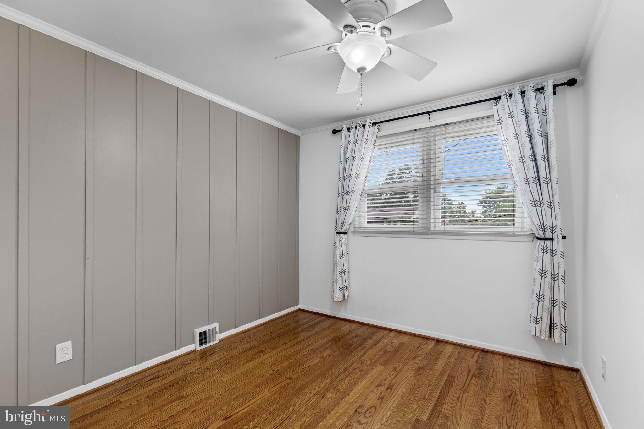 5920 Atteentee Road Springfield, VA 22150 - Photo 20 of 33 a view of an empty room with wooden floor and a window
