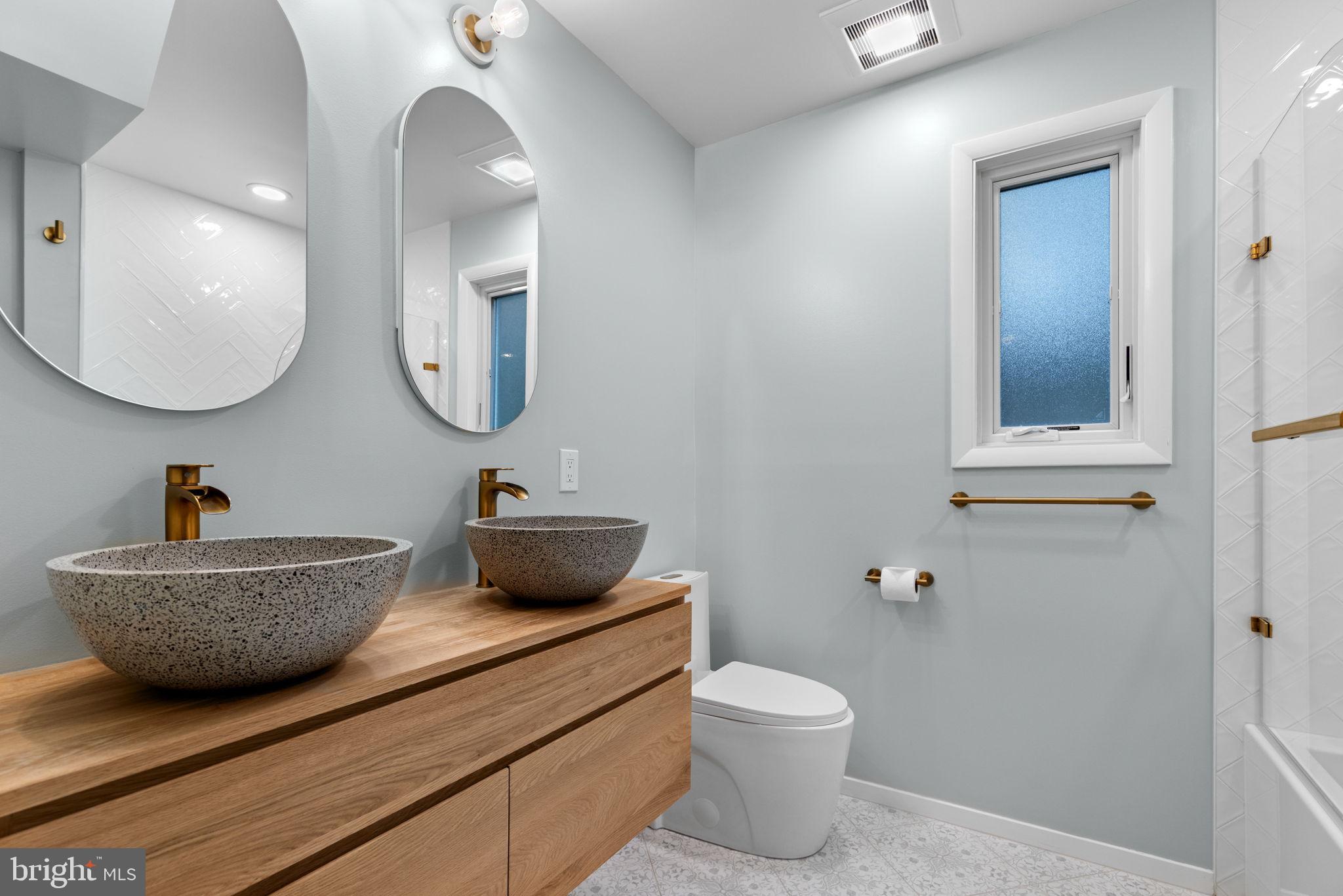 5920 Atteentee Road Springfield, VA 22150 - Photo 21 of 33 a bathroom with a toilet a sink and mirror