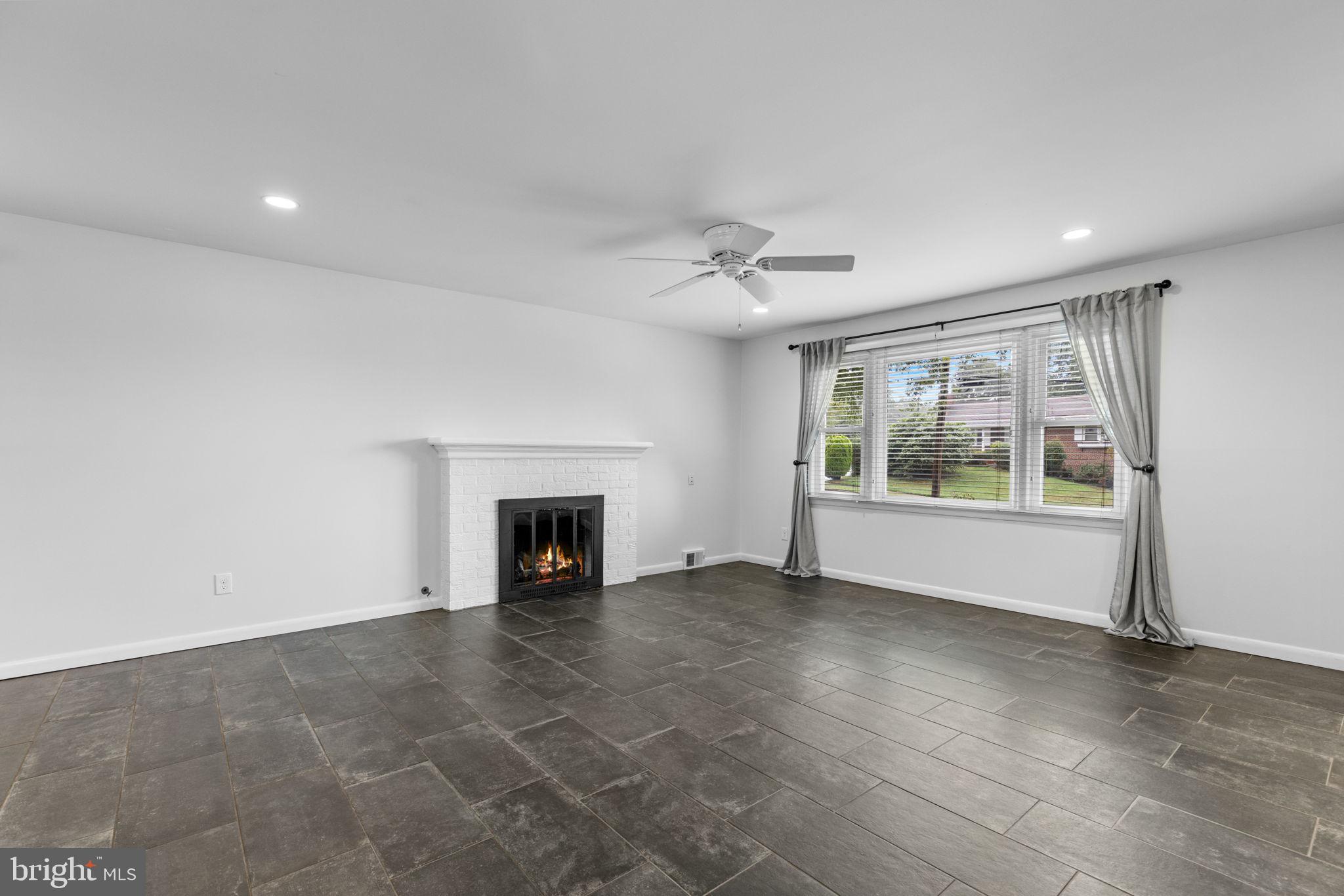 5920 Atteentee Road Springfield, VA 22150 - Photo 4 of 33 a view of an empty room with a fireplace and a window
