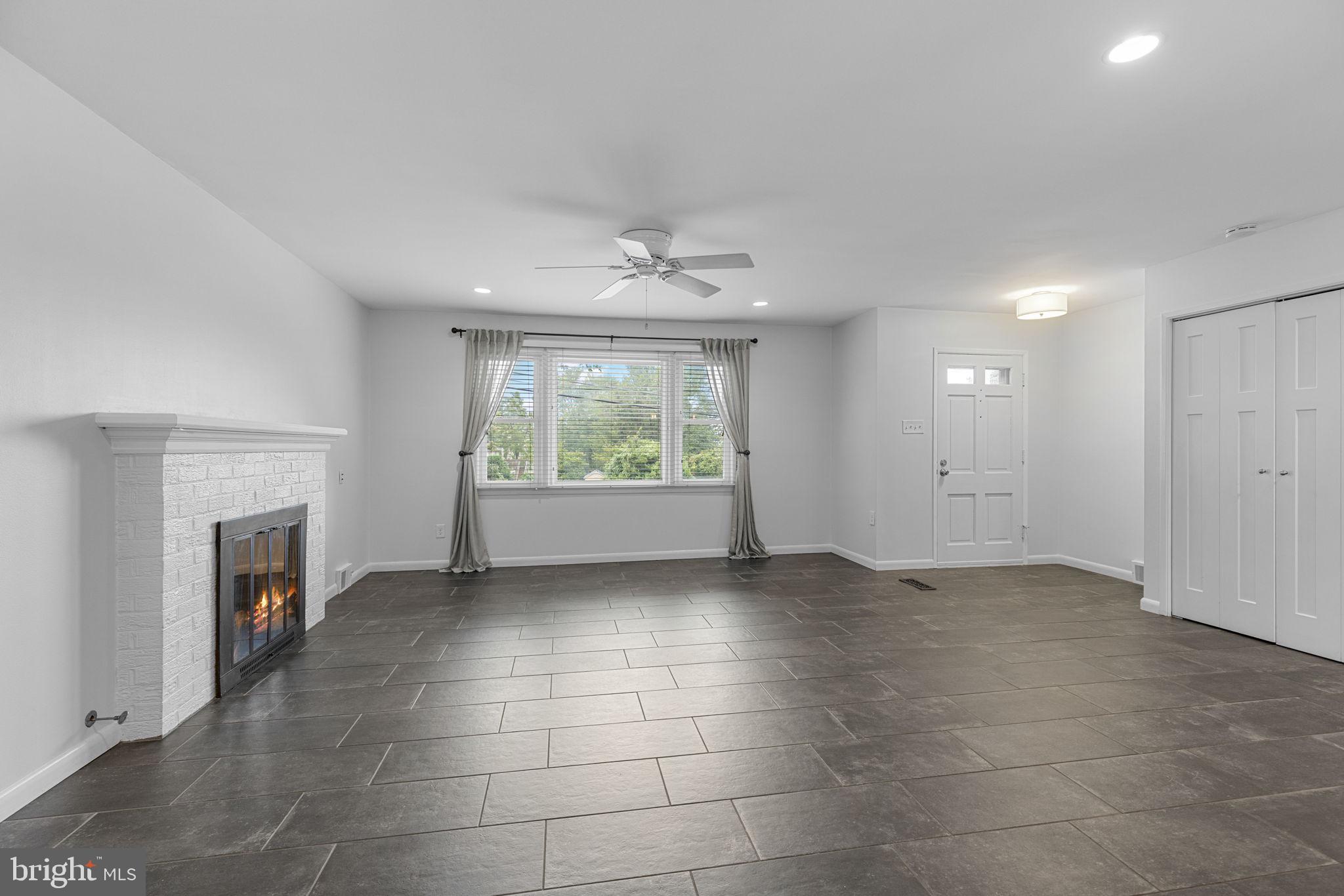 5920 Atteentee Road Springfield, VA 22150 - Photo 5 of 33 a view of an empty room with a fireplace and a window