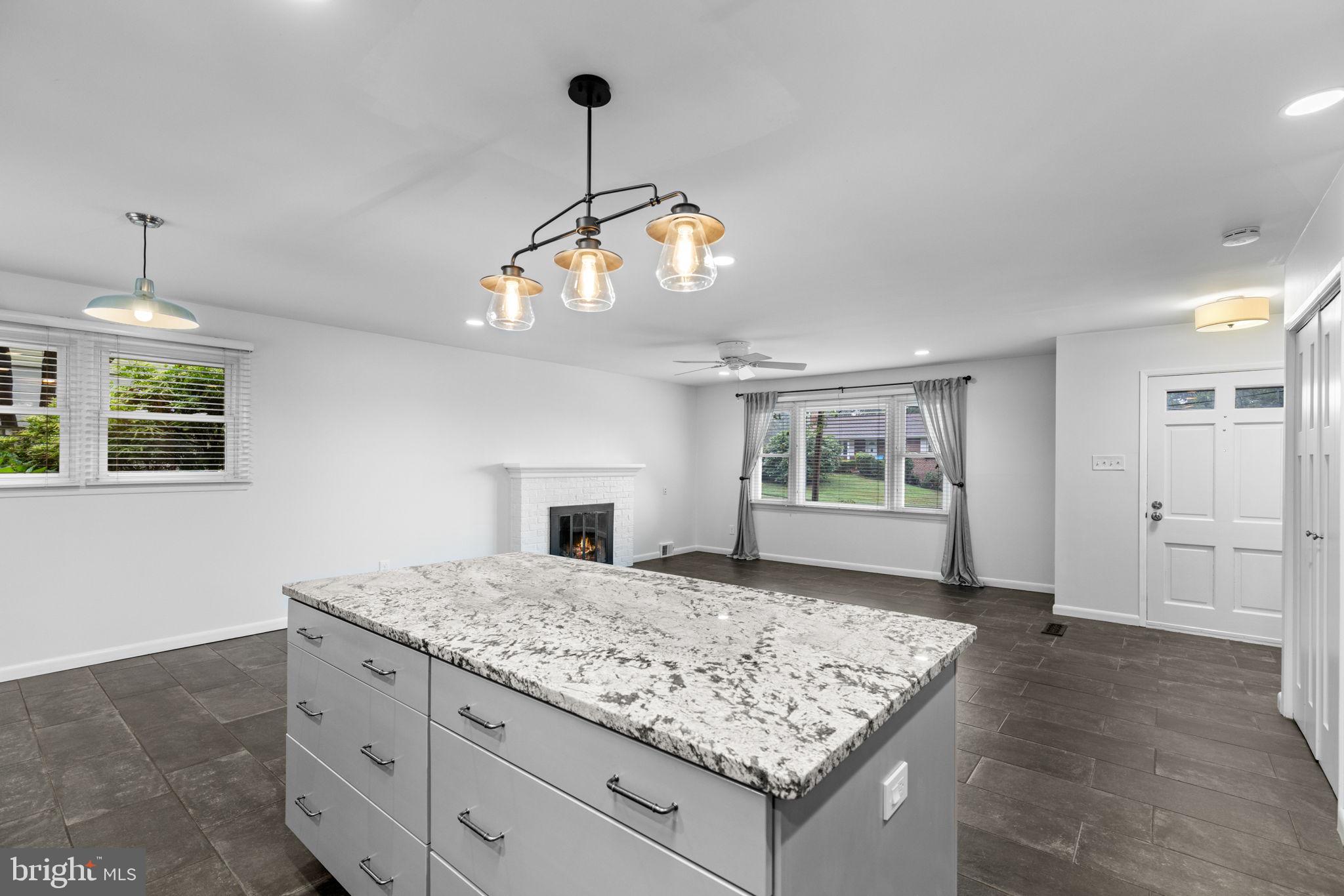 5920 Atteentee Road Springfield, VA 22150 - Photo 9 of 33 a kitchen with kitchen island granite countertop wooden floor and a chandelier