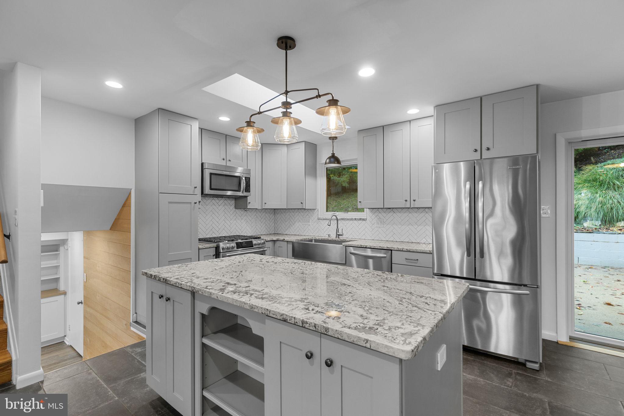 5920 Atteentee Road Springfield, VA 22150 - Photo 10 of 33 a kitchen with kitchen island granite countertop a sink appliances and cabinets