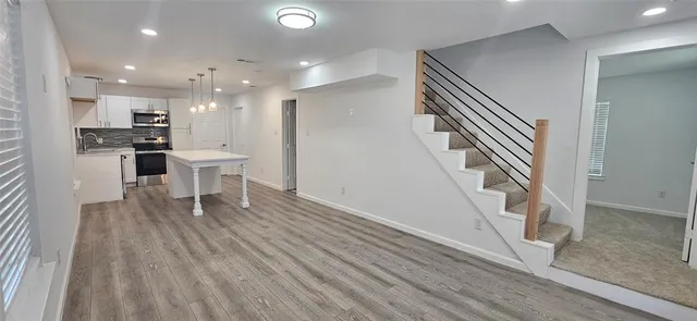 a view of kitchen with furniture and wooden floor