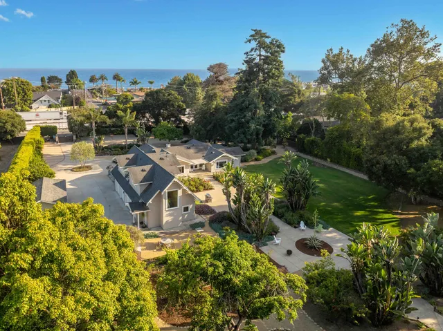an aerial view of a house with a garden and swimming pool