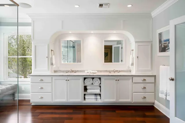 a front view of house with yard and trees in the background