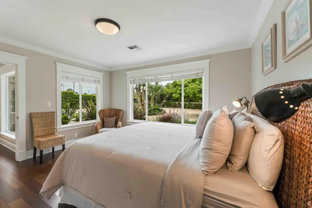 a front view of a house with a yard and potted plants