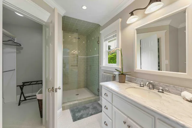 a bathroom with a granite countertop sink a toilet and shower