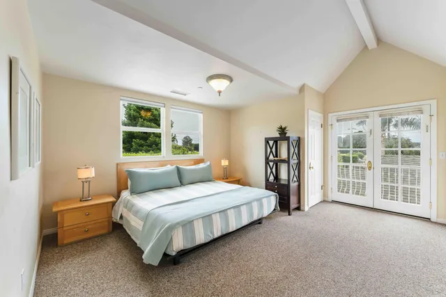 a view of a house with garden and a sitting area