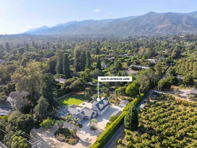a large bathroom with a large mirror vanity and shower