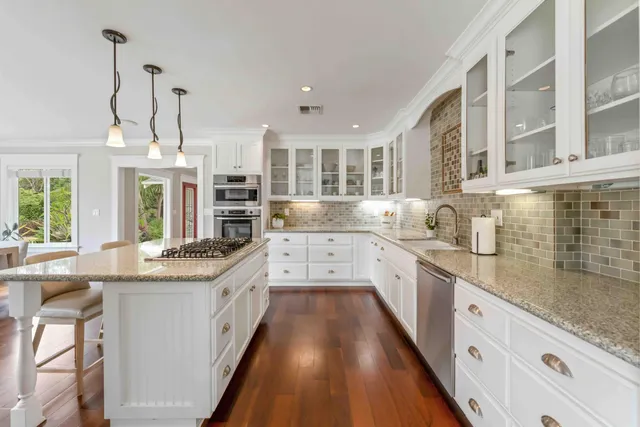 a living room with furniture a fireplace and a floor to ceiling window