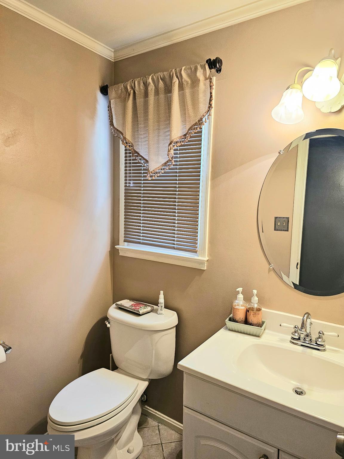 14211 Ansted Road Silver Spring, MD 20905 - Photo 12 of 27 a bathroom with a sink mirror vanity and toilet