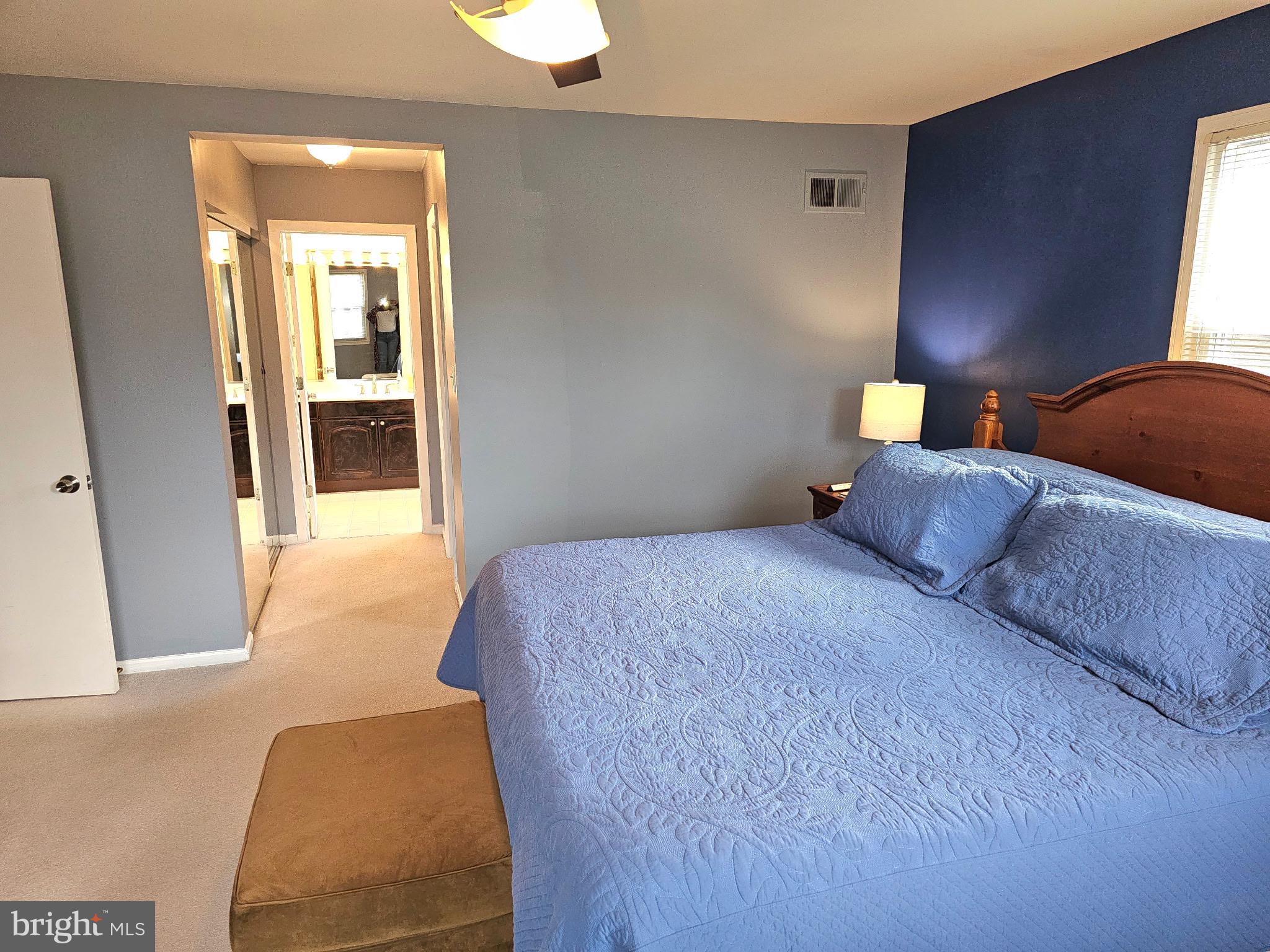 14211 Ansted Road Silver Spring, MD 20905 - Photo 13 of 27 a bedroom with a bed and lamp