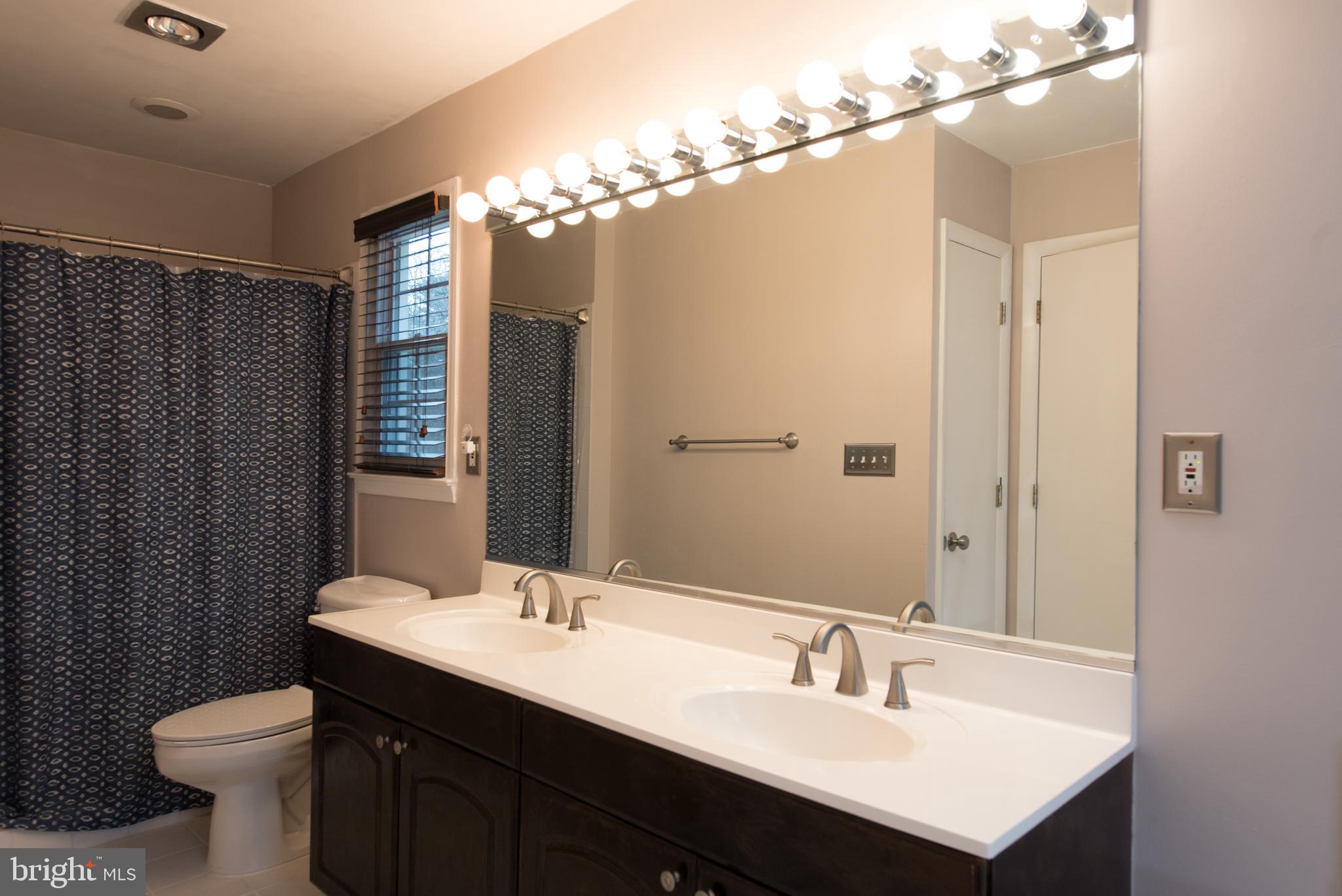 14211 Ansted Road Silver Spring, MD 20905 - Photo 17 of 27 a bathroom with a sink double vanity and a mirror