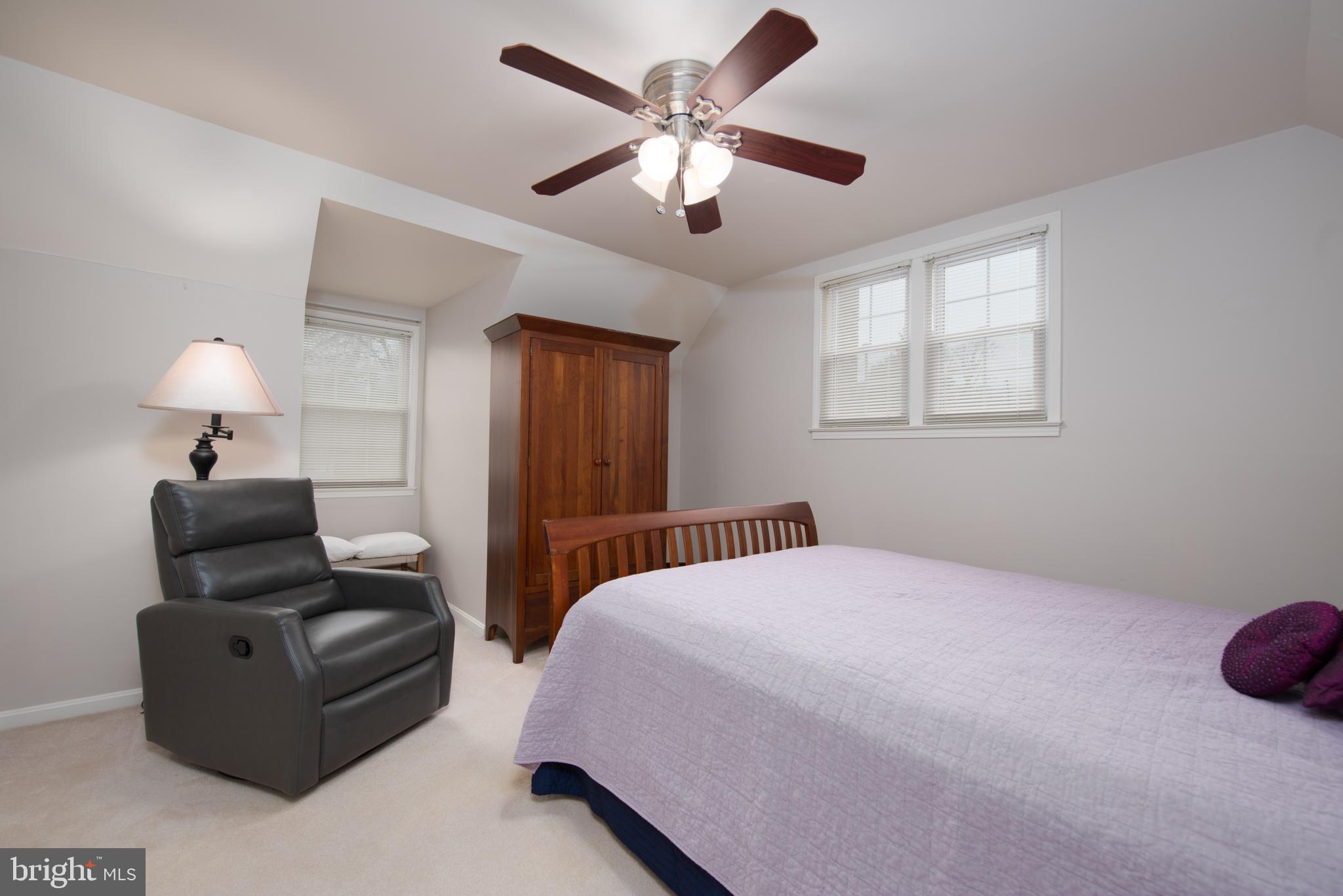 14211 Ansted Road Silver Spring, MD 20905 - Photo 18 of 27 a bedroom with a bed and a chandelier