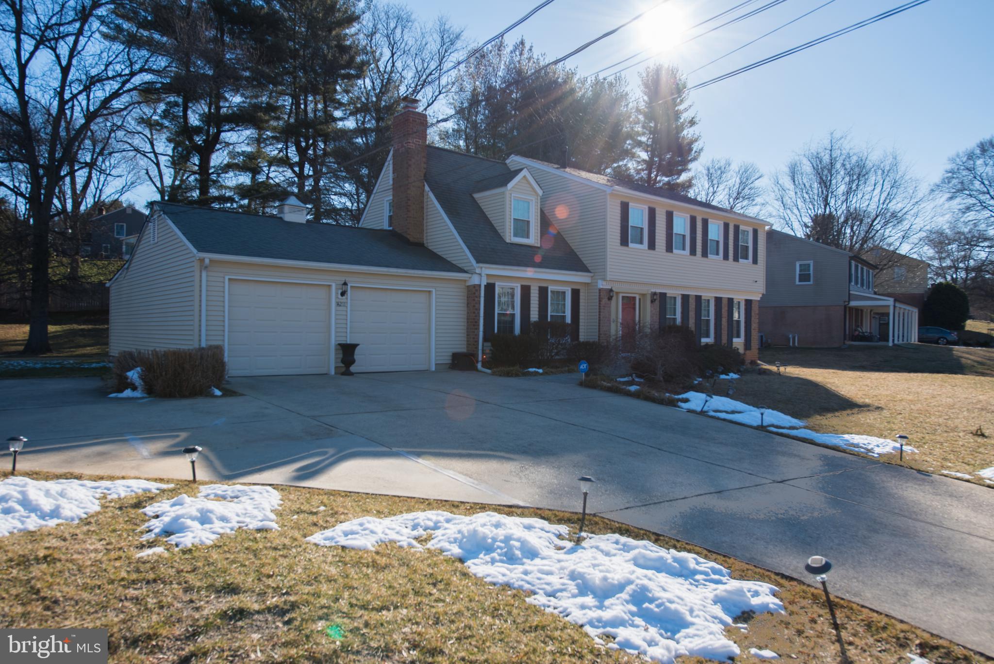 14211 Ansted Road Silver Spring, MD 20905 - Photo 2 of 27 a view of a white house with a yard covered in snow