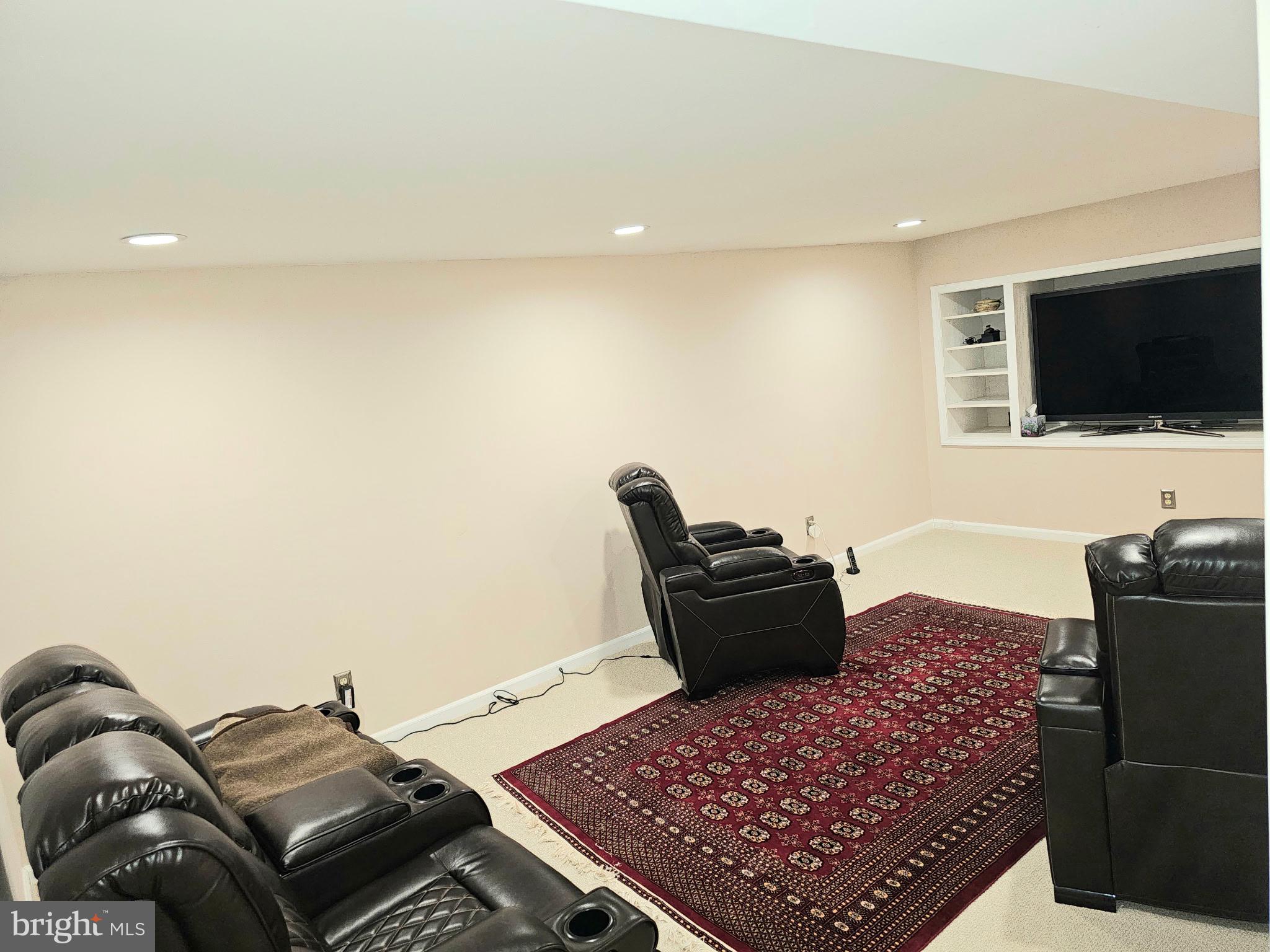 14211 Ansted Road Silver Spring, MD 20905 - Photo 22 of 27 a living room with furniture and a flat screen tv