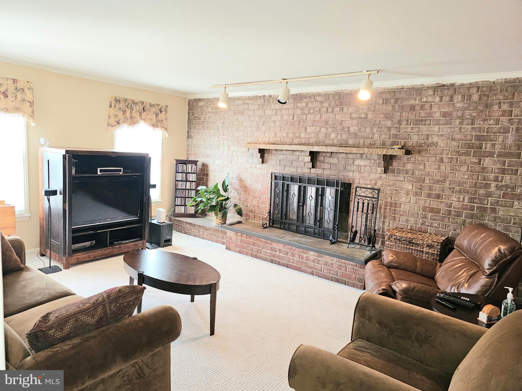 14211 Ansted Road Silver Spring, MD 20905 - Photo 6 of 27 a living room with furniture and a fireplace