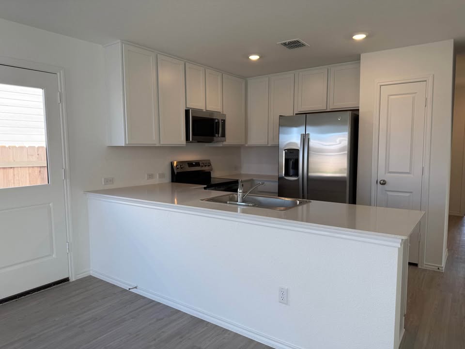 113 Marty Allen Loop Jarrell, TX 76537 - Photo 2 of 16 Bright White Cabinets, Stainless Appliances and Quartz Counter-tops in the Kitchen
